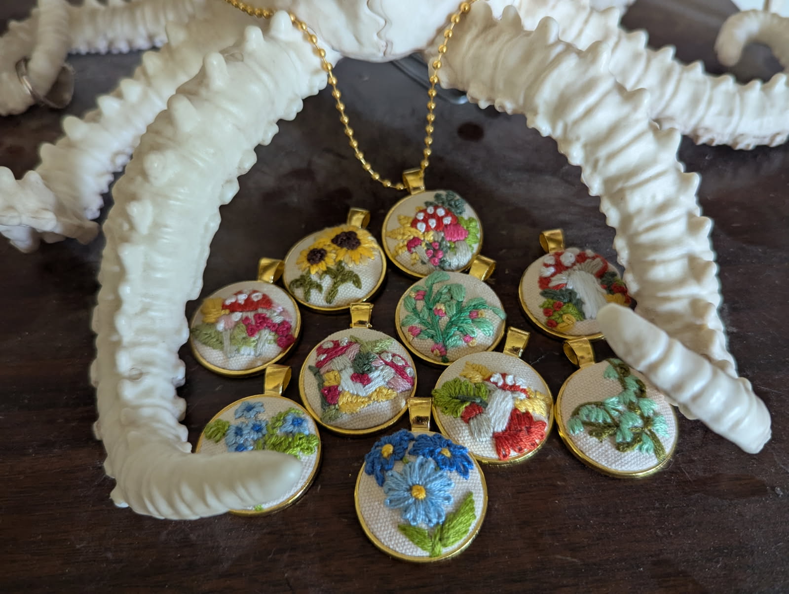 Hand-embroidered jewelry and accessories featuring freehand embroidery designs, one-of-a-kind handmade fiber art pieces