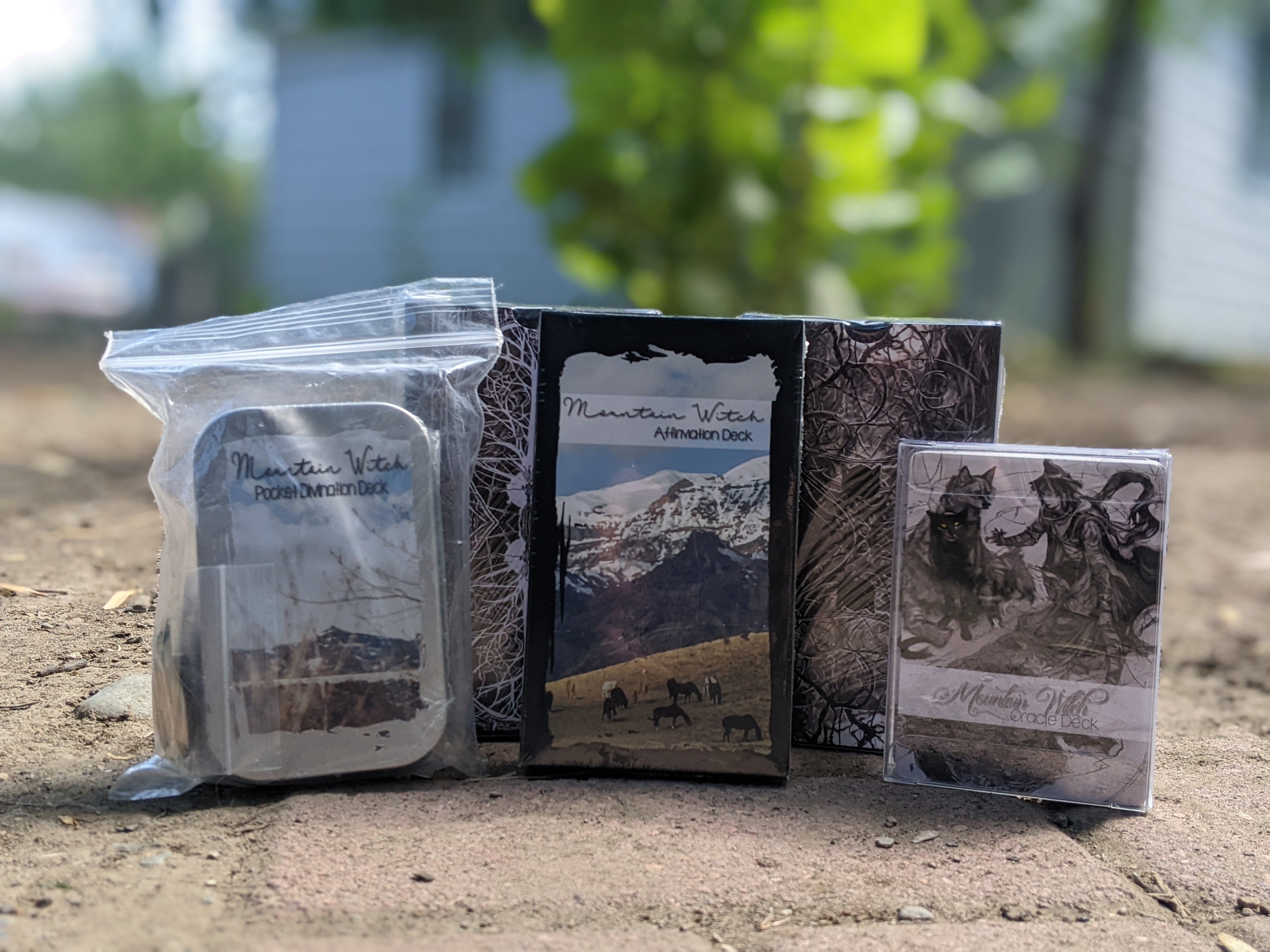 Mountain Witch divination tools inspired by the landscapes of Colorado, Wyoming, and Montana, featuring tarot decks, oracle decks, affirmation cards, and portable divination kits.