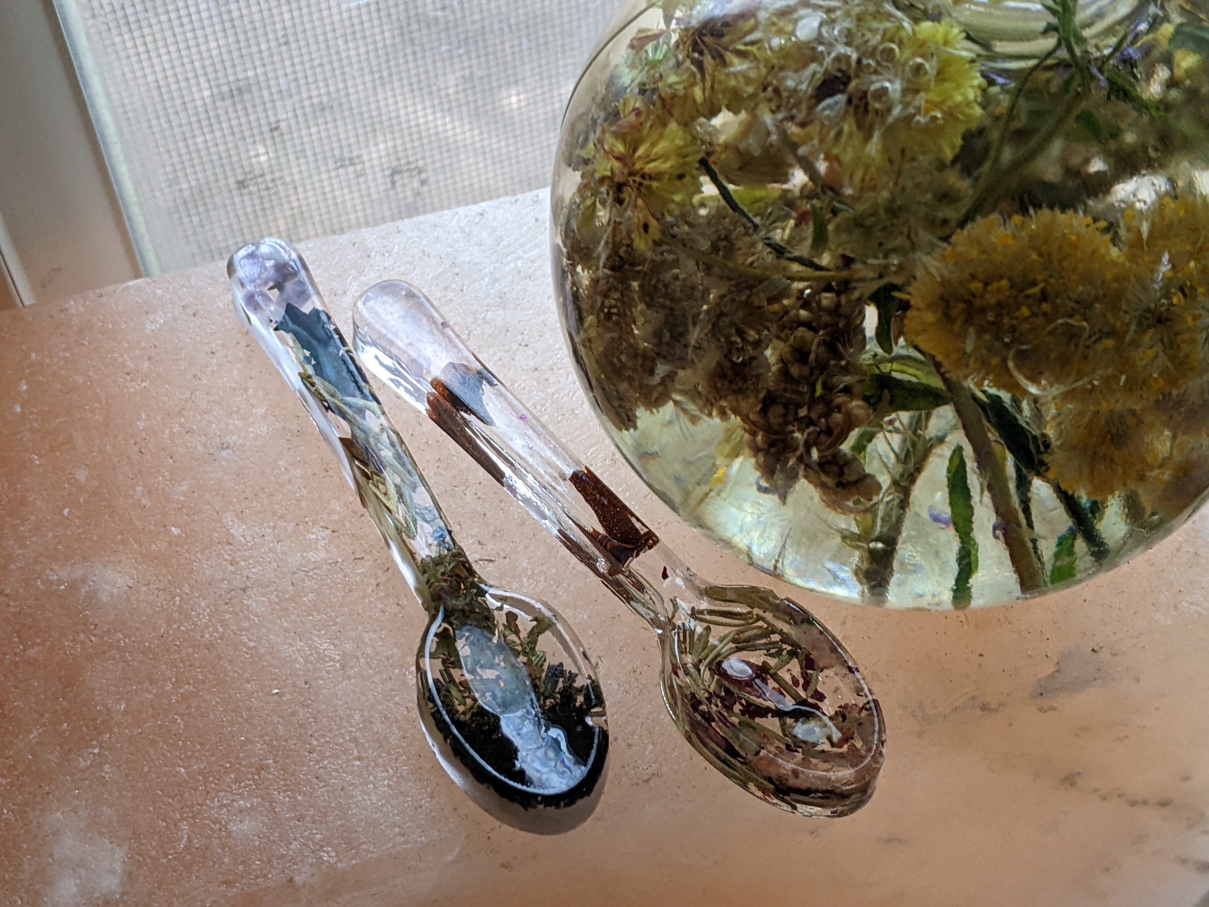 Handcrafted spell spoon trio made with resin, herbs, stone chips, and flower petals