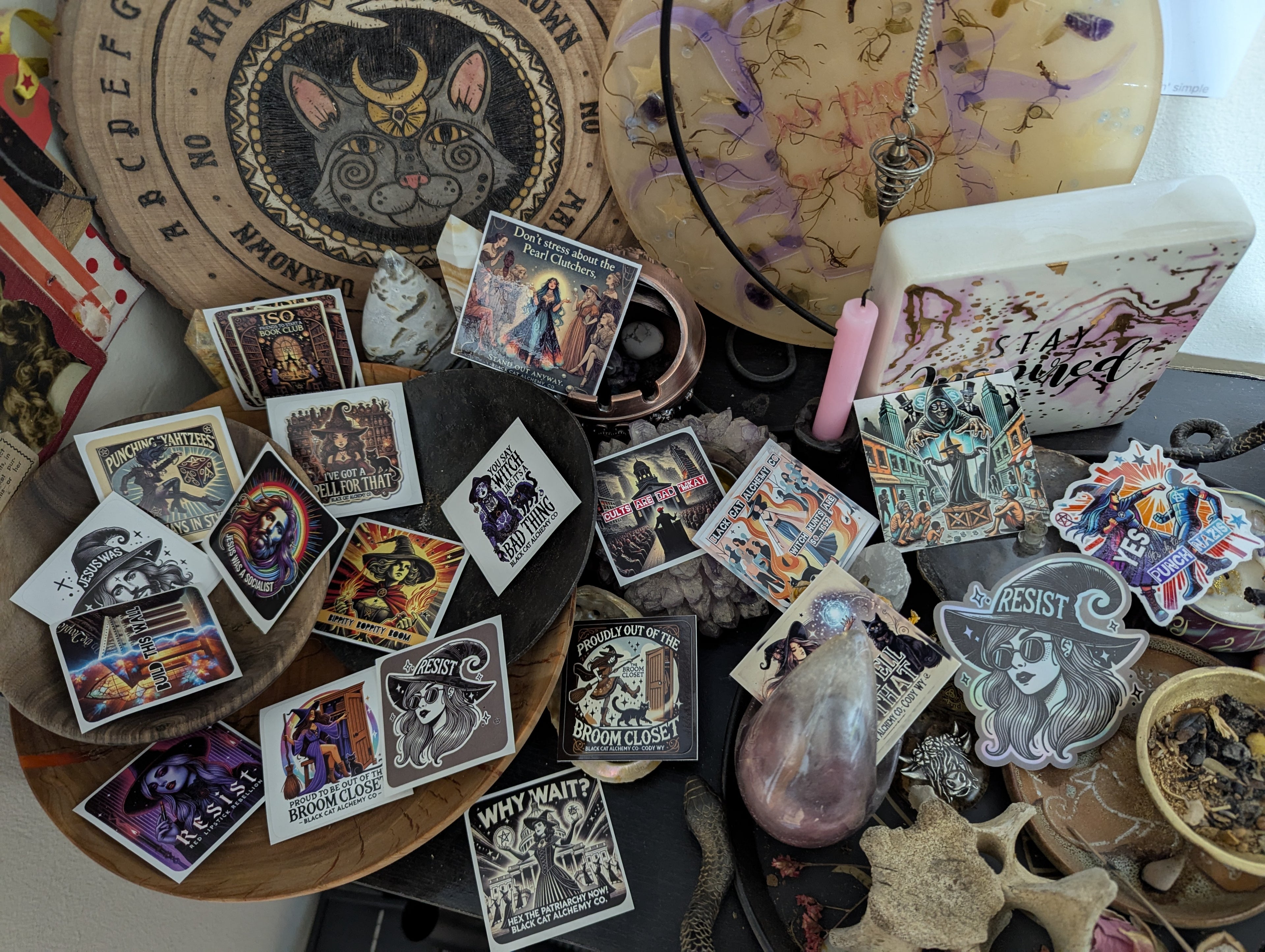 A collection of various stickers with magical and rebellious themes displayed on a surface.