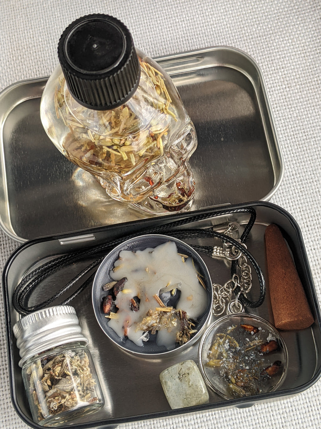 Shadow Work Bundle for healing and self-discovery, featuring a spell box with herbs and labradorite, a handcrafted shadow work necklace, and skull bottle meditation oil for grounding and inner reflection.