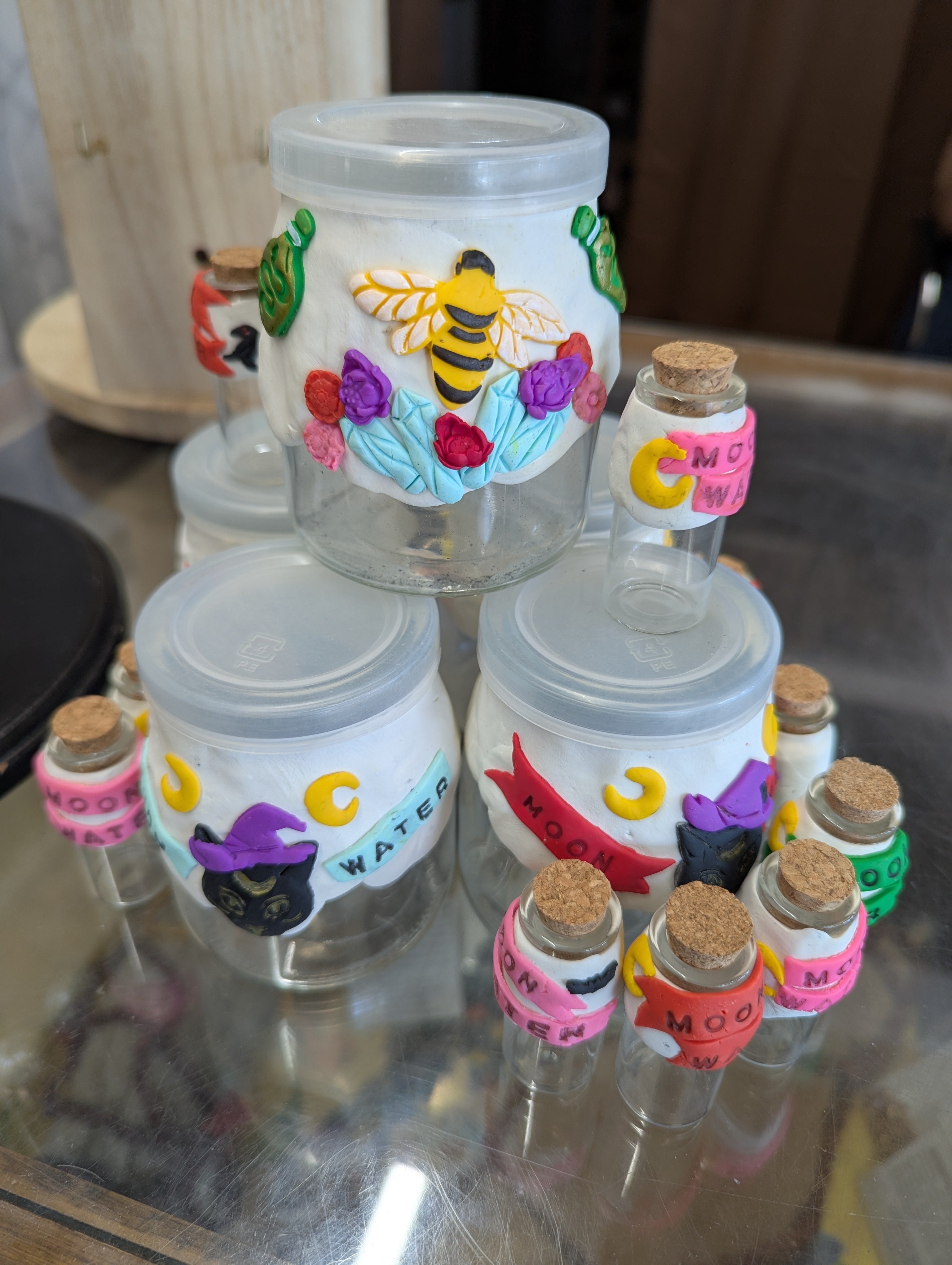 Handcrafted moon water jar with hand-sculpted clay decoration for rituals