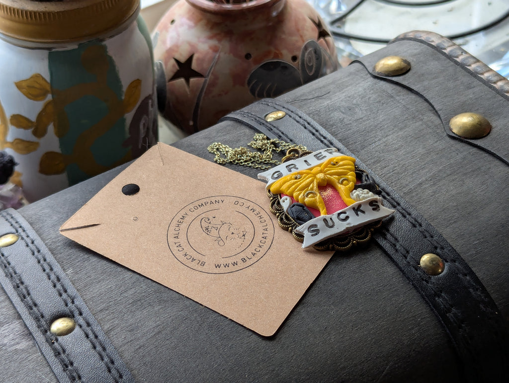 Grief Sucks necklace inspired by the grief moth, handcrafted memorial jewelry