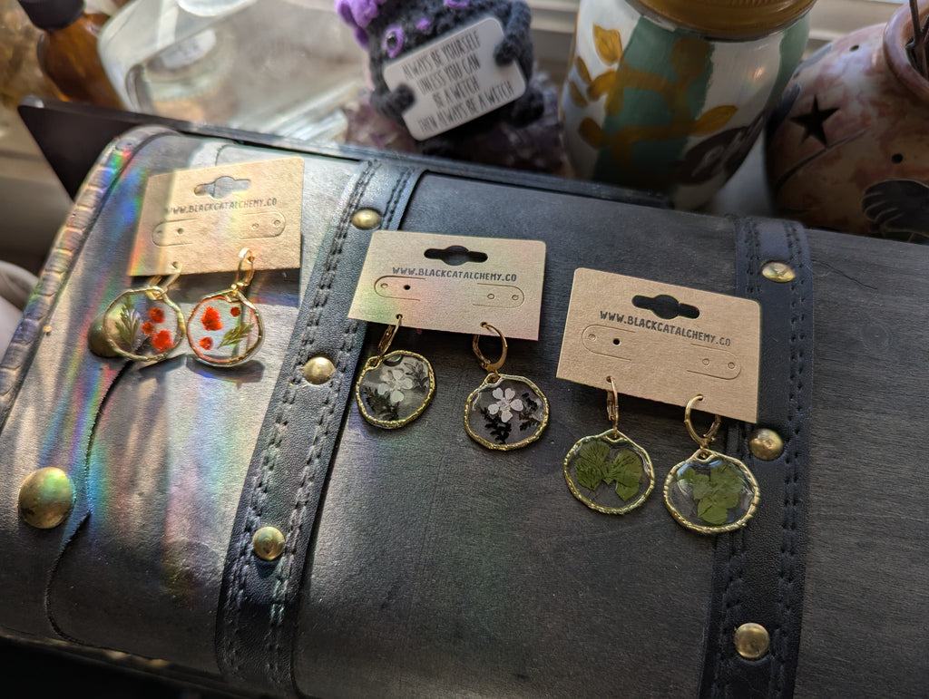 Pressed flower resin earrings in open bezel design on lever back hooks