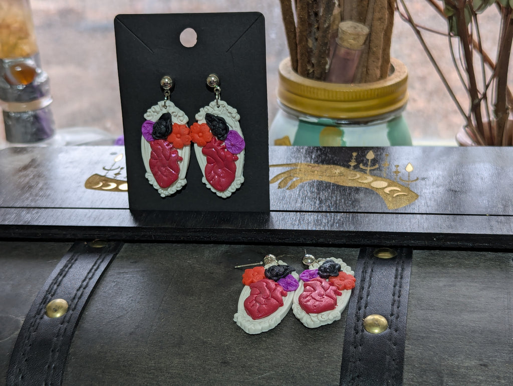 Hearts aBloom earrings featuring hand-sculpted polymer clay anatomically correct heart surrounded by flowers in antique-style frame