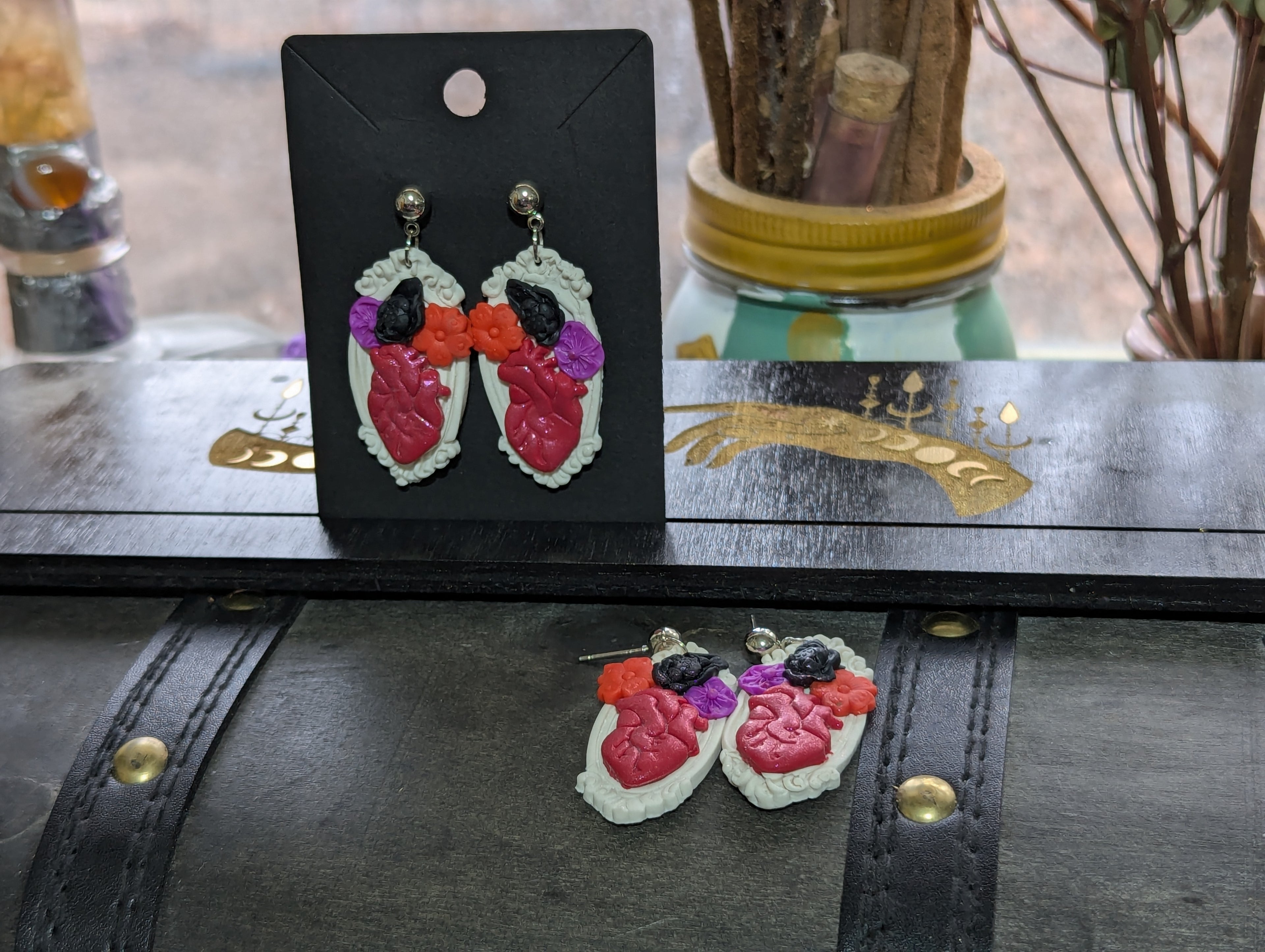 Hearts aBloom earrings featuring hand-sculpted polymer clay anatomically correct heart surrounded by flowers in antique-style frame