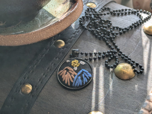Hand-embroidered jewelry and accessories featuring freehand embroidery designs, one-of-a-kind handmade fiber art pieces