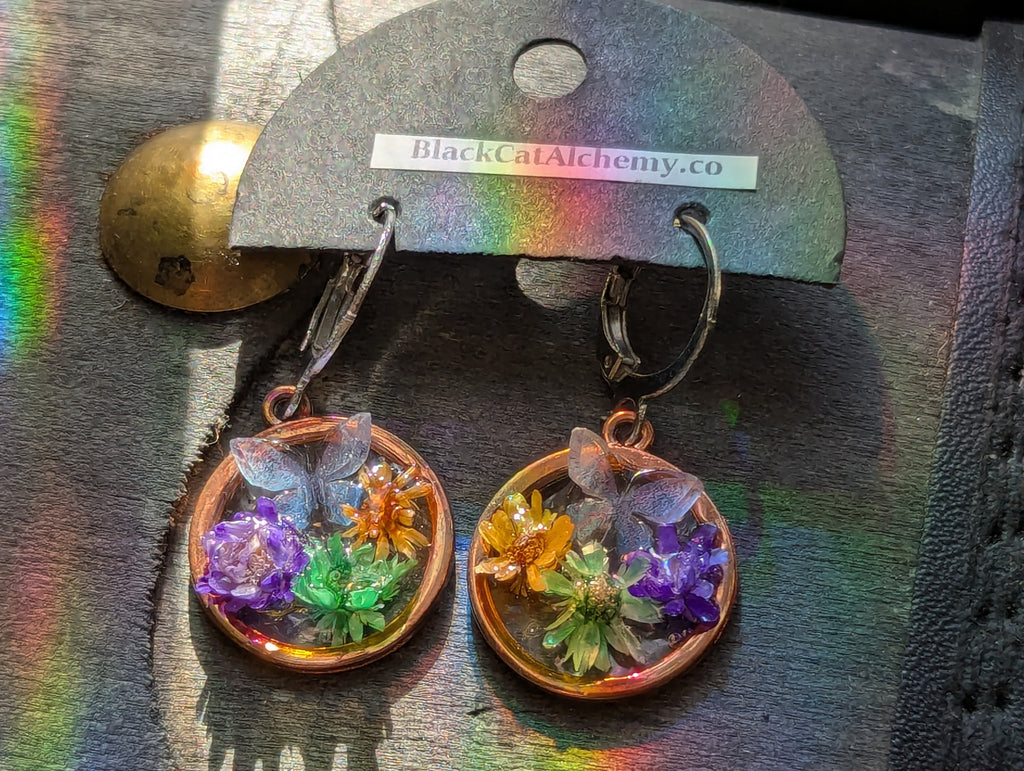 Handmade botanical earrings featuring flowers and butterfly details