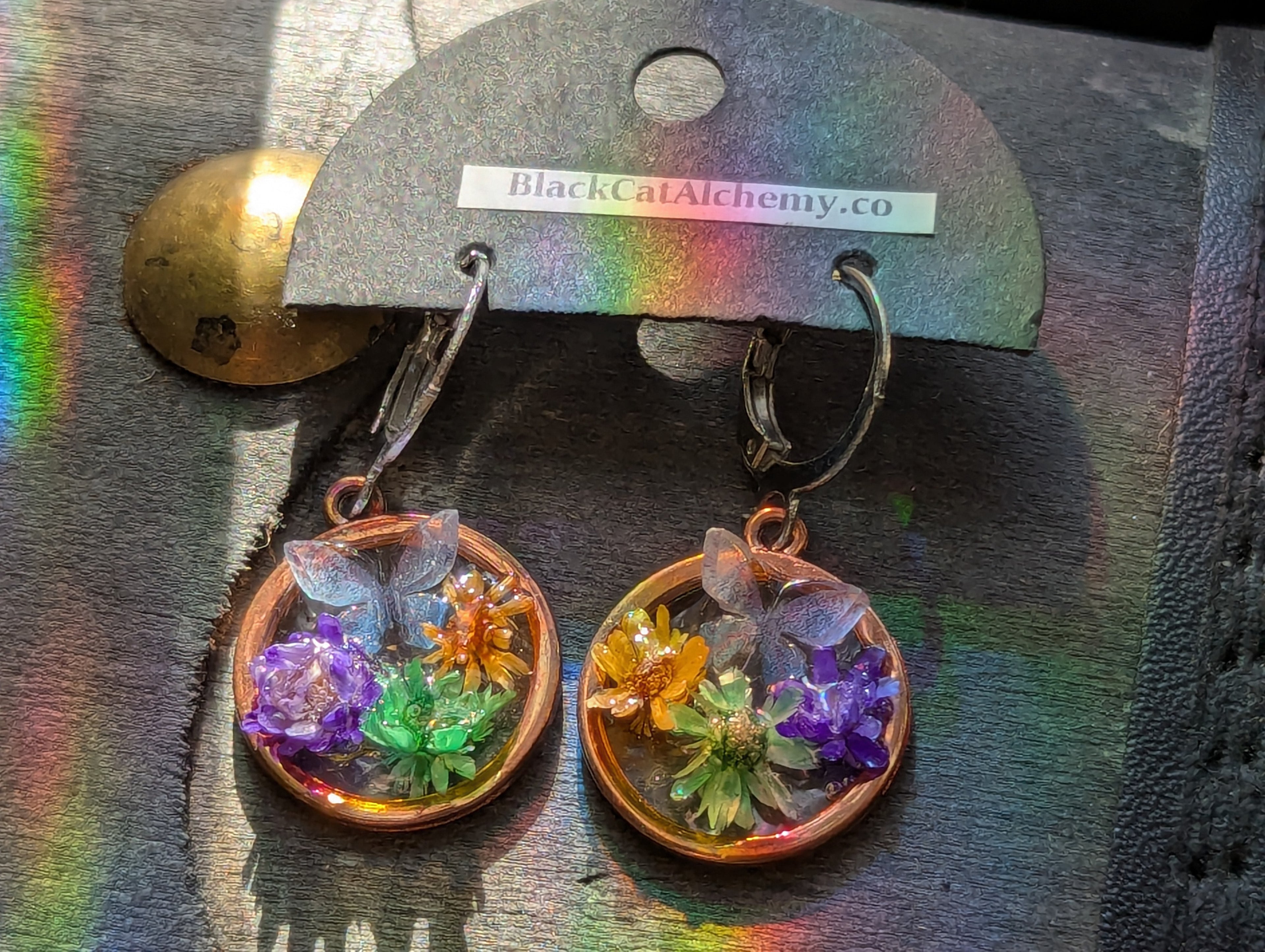 Handmade botanical earrings featuring flowers and butterfly details