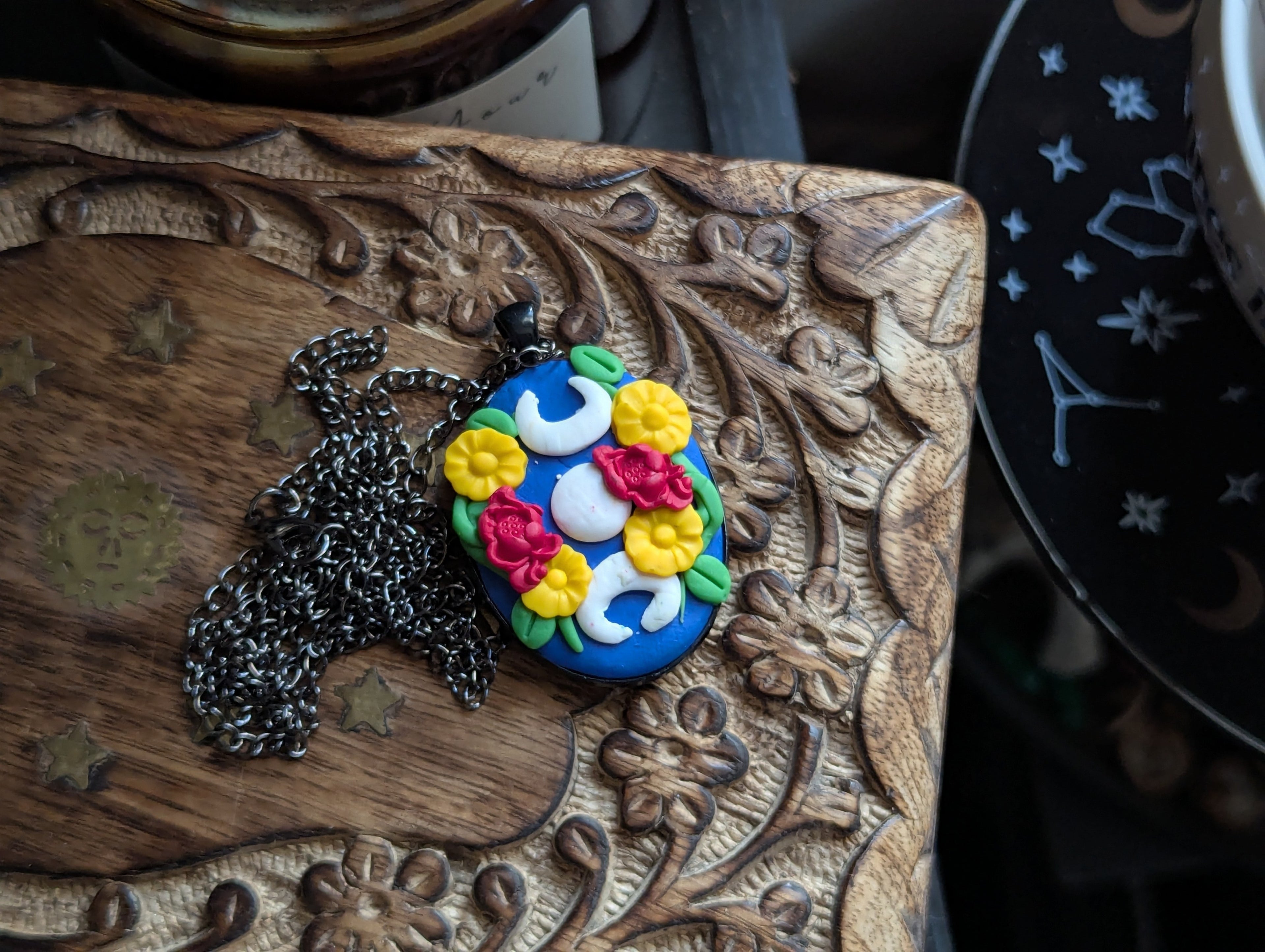 Hand sculpted clay moon magic pendant with celestial witch aesthetic