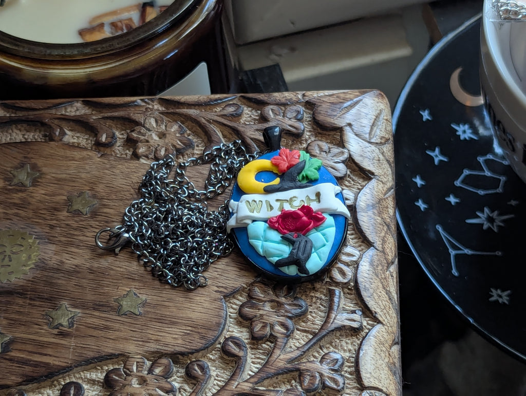 Handcrafted witch necklace featuring hand-sculpted polymer clay statement design