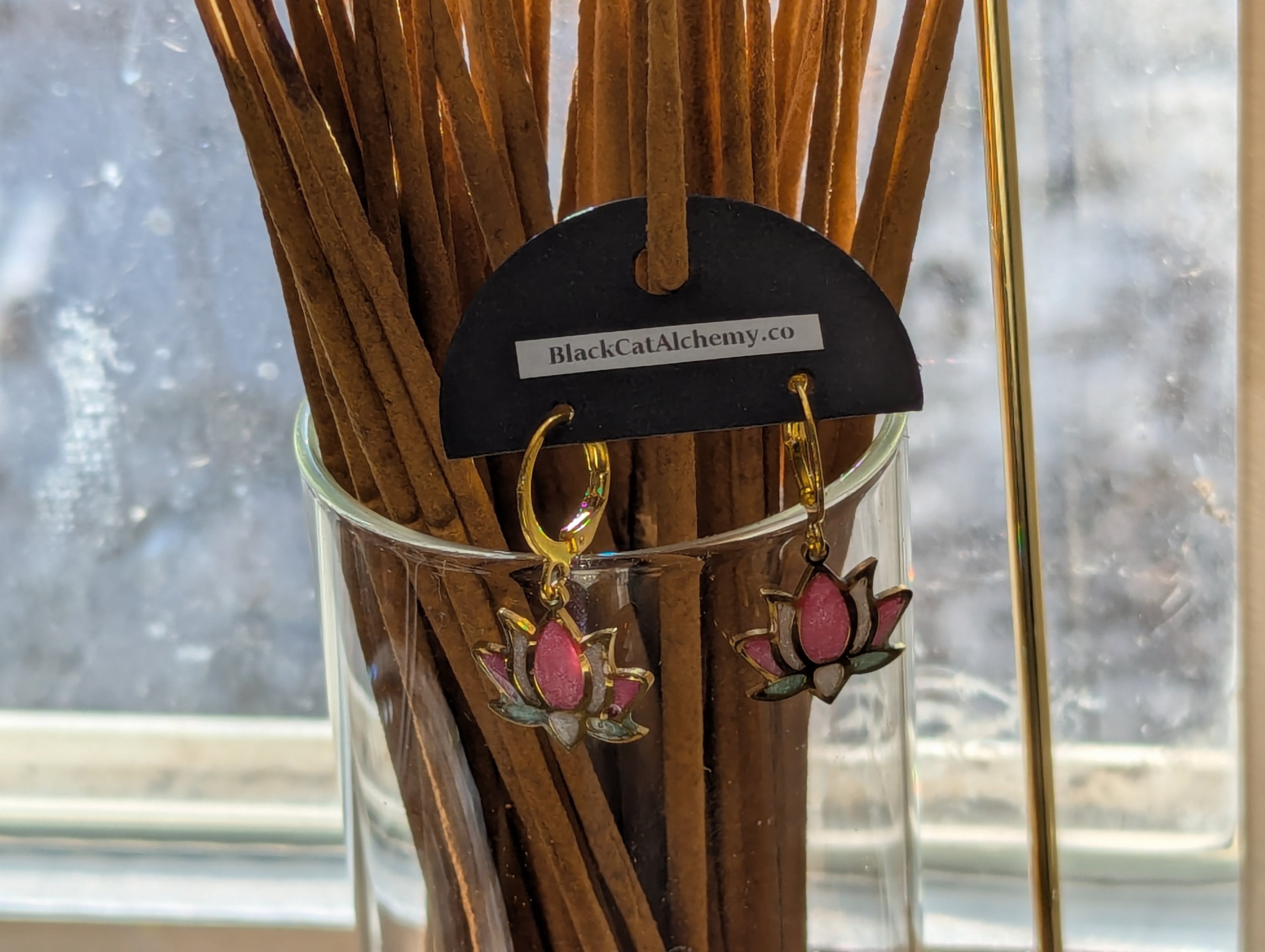Dainty lotus earrings on hypoallergenic lever back hooks in silver and gold