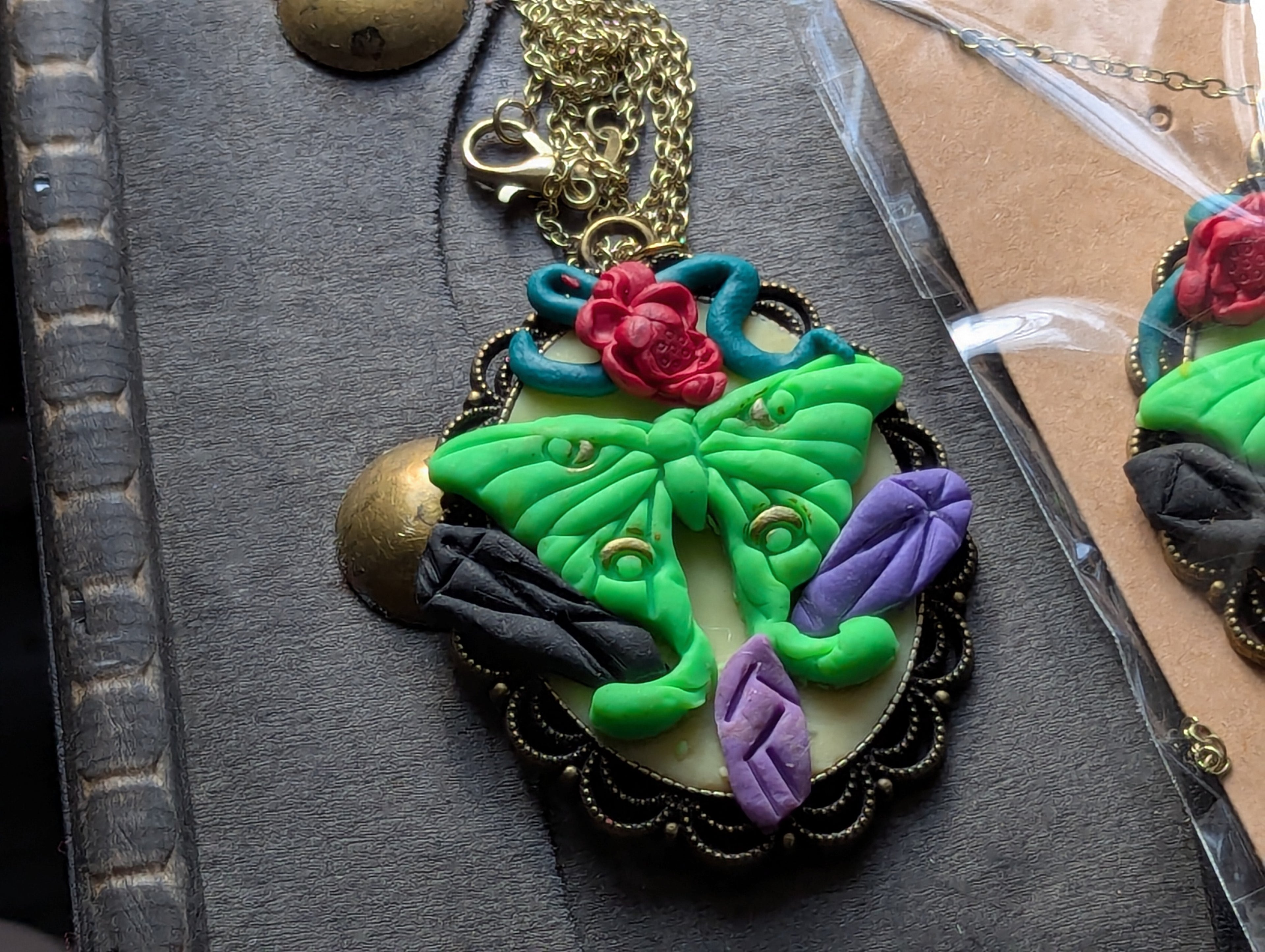 Hand sculpted clay mystic moth statement necklace with gothic magical aesthetic
